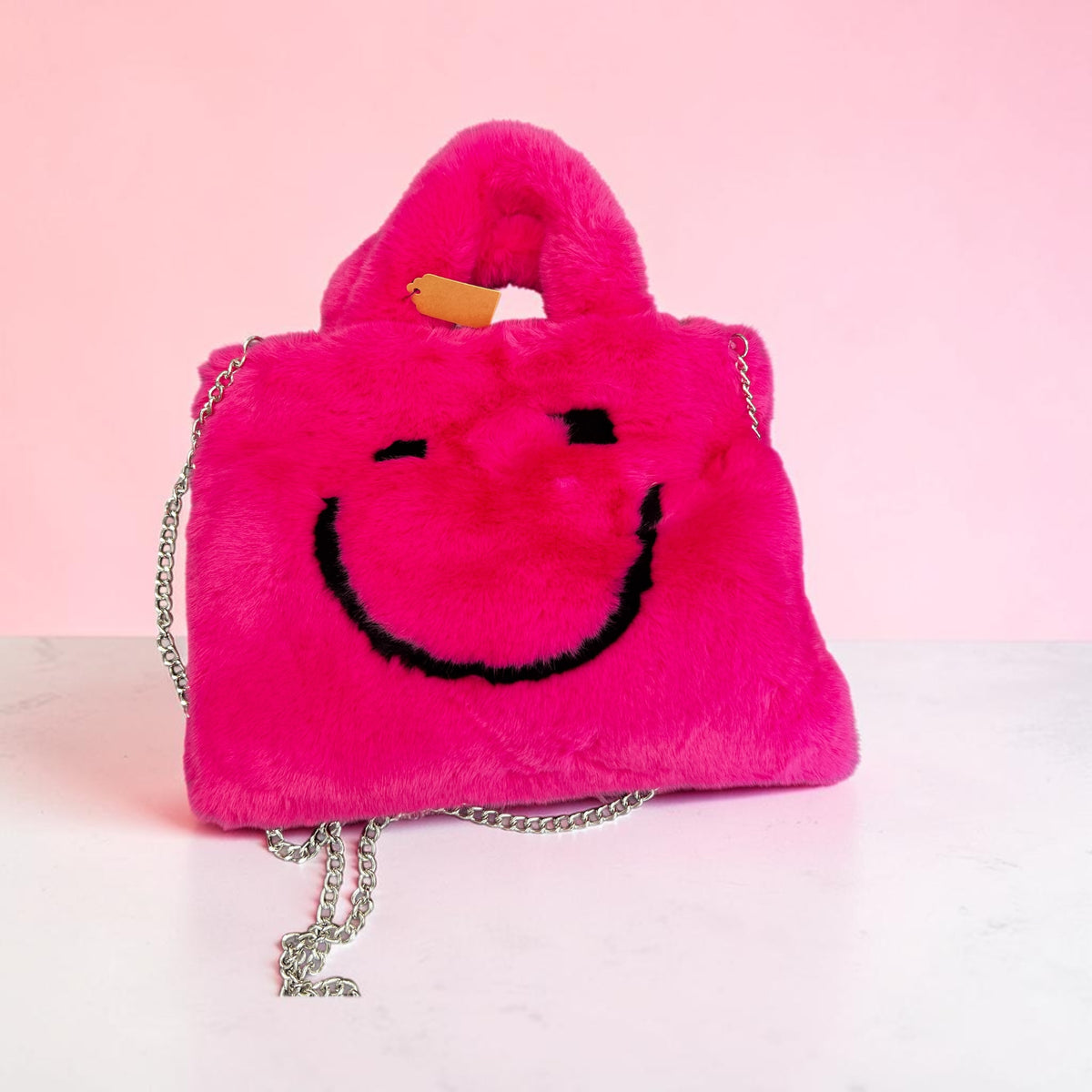 Fake bont tasje met lang hengsel in fel roze