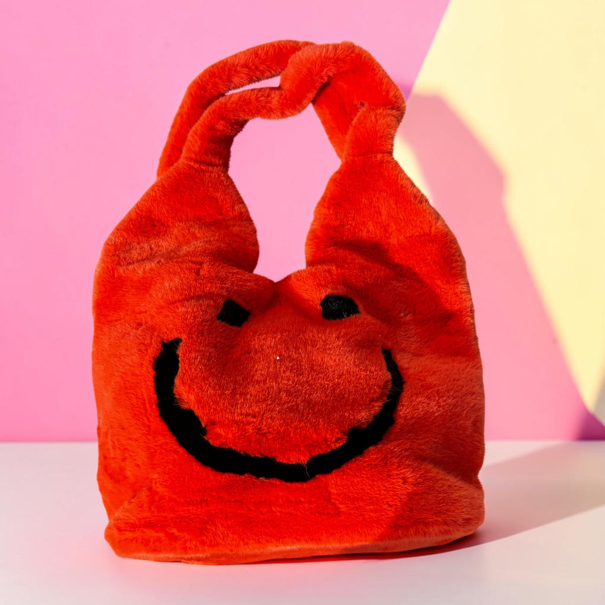 Grote fake bont tas met smiley in oranje